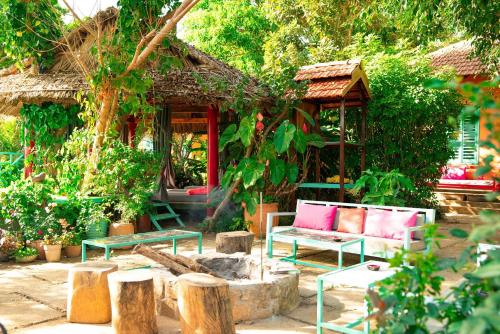 a house with two benches and a fire place at Ivory Falls Villa in Di Linh