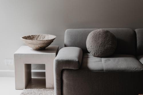 a living room with a couch and a bowl on a table at Boutique stylish 3 Bedroom family home in Melbourne with Parking in Melbourne