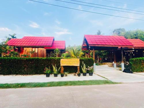 two buildings with red roofs and a sign in front at Nadia Resort Kohjum in Ko Jum