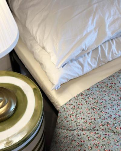 a bed with a pillow and a stool next to it at Nhà trong hẻm bên sông in Vung Tau