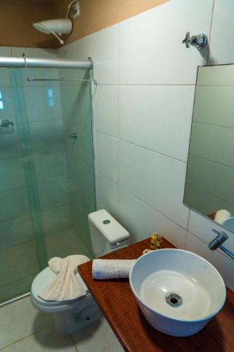 a bathroom with a sink and a shower and a toilet at Apprezzare . Pousada beira-mar in Porto De Galinhas
