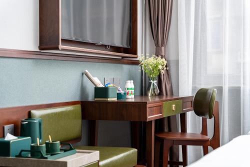 a hotel room with a desk and a chair at Nost algia S Hotel Chengdu KuanZhai Alley & Renmin Park 时光漫步S酒店 成都宽窄巷子人民公园地铁站店 Free fresh ground coffee,Free laundry service in Chengdu