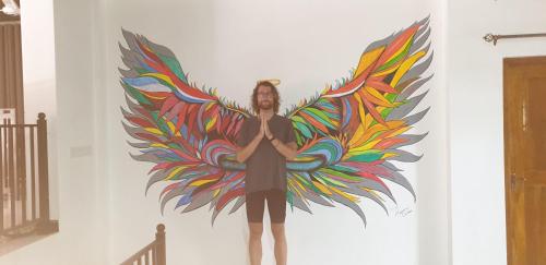 a man standing in front of a wall with a painting at Enara Luxury Stay in Katugastota