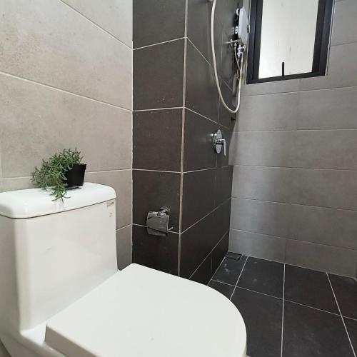 a bathroom with a toilet and a shower at New 2BR or 3BR Homey Getaway stay 7 to 10 pax at Urban Suites, Georgetown by URBAN STAYCATION LOD in Jelutong