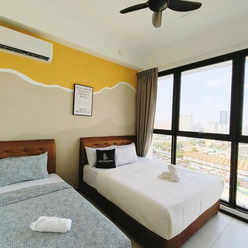 a bedroom with two beds and a ceiling fan at New 2BR or 3BR Homey Getaway stay 7 to 10 pax at Urban Suites, Georgetown by URBAN STAYCATION LOD in Jelutong