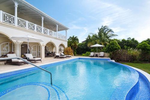 a swimming pool in front of a house at Royal Westmoreland - Ocean Drive 8 villa in Saint James