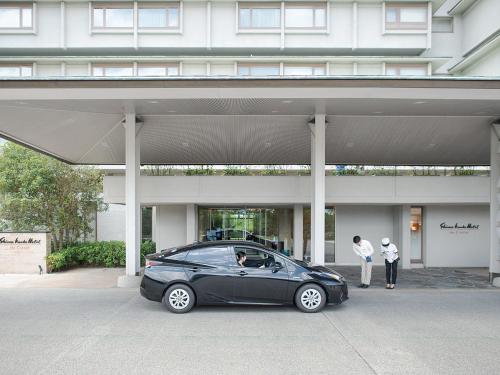 a black car parked in front of a building at Shima Kanko Hotel The Classic in Shima