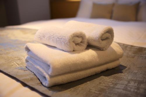 a pile of towels sitting on top of a table at KYOTO GION HOTEL in Kyoto
