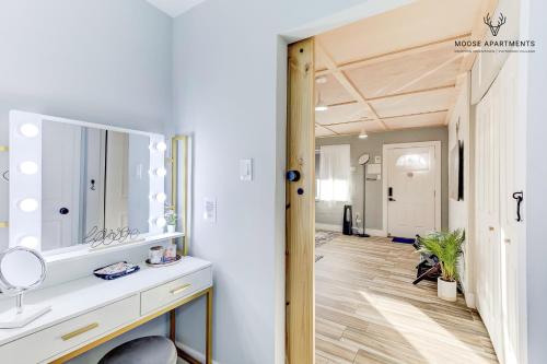 a bathroom with a sink and a mirror at The Moose at Memphis Downtown & Victorian Village in Memphis