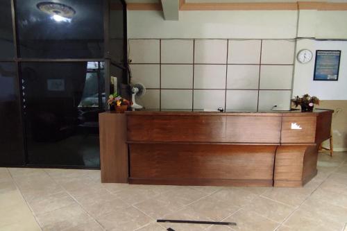 a kitchen with a wooden counter top in a room at Hotel O Pondok Bintang in Kendari