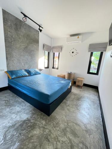 Un dormitorio con una cama azul en el medio. en บ้านพักสุดซอย, en Ban Rai