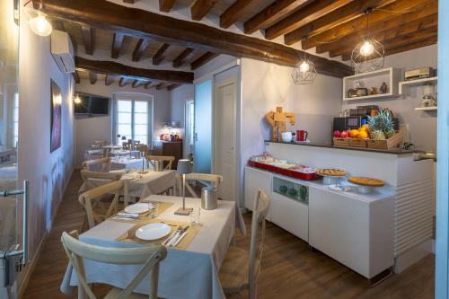 a restaurant with a table and chairs in a room at Hotel Cortaccia Sanvitale in Sala Baganza
