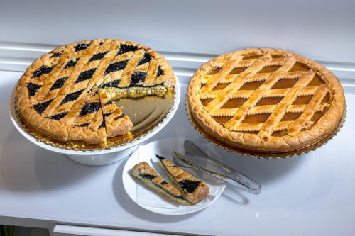 two pies sitting on a table with a plate at Hotel Cortaccia Sanvitale in Sala Baganza