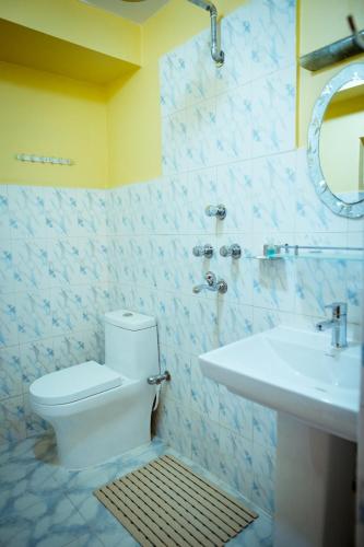 a bathroom with a toilet and a sink at Paradise Boutique Hotel in Pokhara