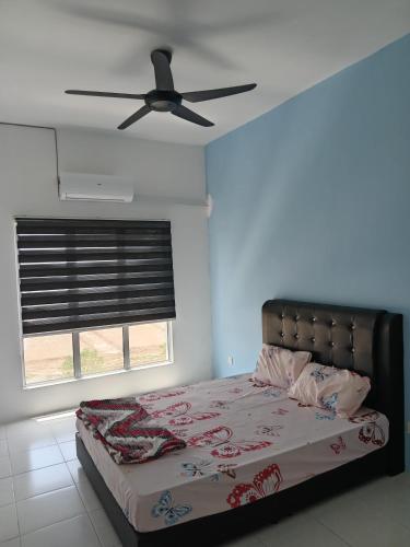 a bedroom with a bed with a ceiling fan at Dream House in Chemor