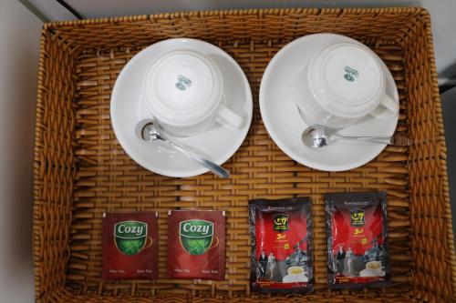a wicker basket with plates and cups and snacks at Adventure Hotel in Ho Chi Minh City