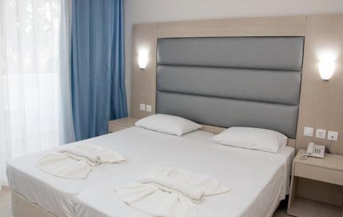 Ένα ή περισσότερα κρεβάτια σε δωμάτιο στο Marathon Hotel - All Inclusive