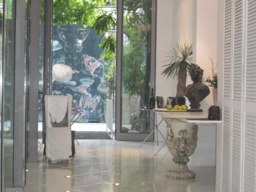 a hallway with glass doors and a table with plants at Pallazzo Alfonso in Aachen