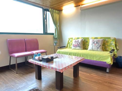 a living room with a couch and a table at Old Street Seaview Homestay in Jiufen