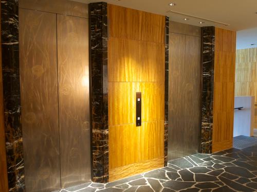a elevator in a room with wood paneling at Shima Kanko Hotel The Bay Suites in Shima
