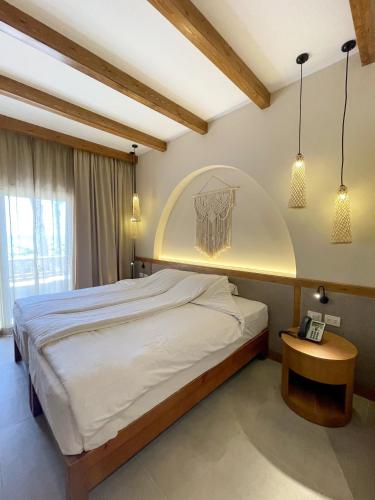 a bedroom with a large bed and a table at The Breakers Diving and Surfing Lodge Soma Bay in Hurghada
