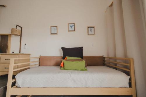 a bed with two pillows on it in a room at Tres Velas Surf in Celestino Gasca