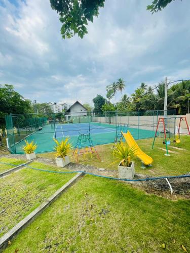 a park with a playground with a slide at Hideout Ariyana in Athurugiriya