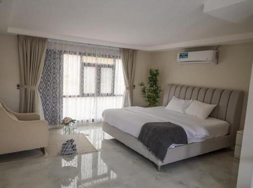 a bedroom with a large bed and a window at Safari Desert Camp in Shāhiq