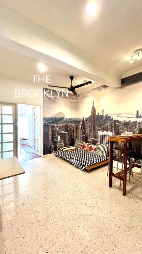 a bedroom with a city skyline mural on the wall at The Brooklyn in Bentong