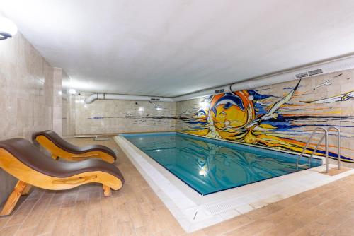 a swimming pool in a room with a painting on the wall at Valens Old City Family & SPA Hotel in Istanbul