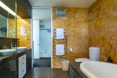 a bathroom with a tub and a sink at Kina Retreat - Luxury Nelson Getaway in Tasman