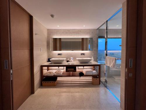 a bathroom with two sinks and a view of the ocean at Shima Kanko Hotel The Classic in Shima