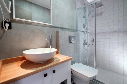 a bathroom with a sink and a shower and a toilet at Meet İstanbul Hotel Kadikoy in Istanbul