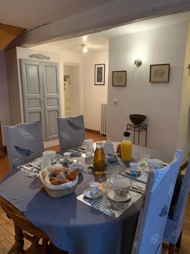 a table with a blue table cloth and a bowl of food at les mésanges in Bourré