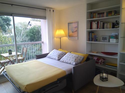 a bedroom with a bed and a balcony at Résidence Arguin 2 in Arcachon