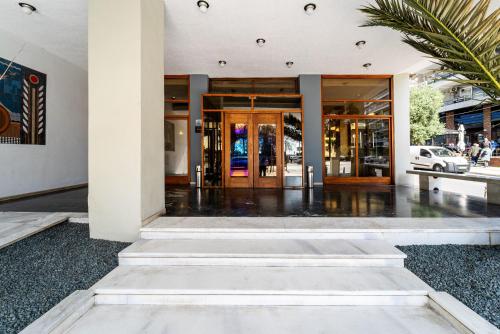 a lobby of a building with glass doors at Oceanis Hotel in Kavála