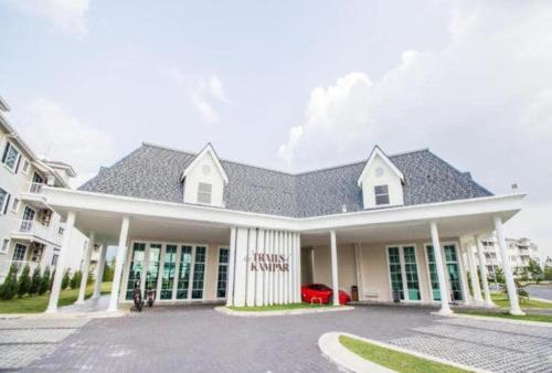 a large white house with a black roof at The Trails Kampar in Kampong Malim Nawar