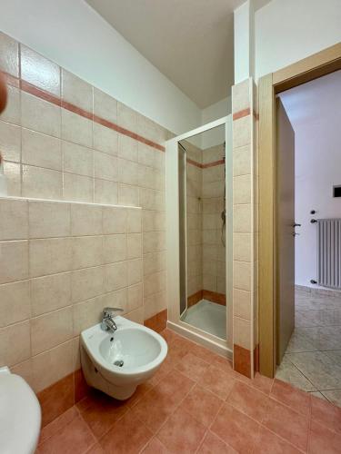 a bathroom with a sink and a toilet and a shower at 1Dest - Waterfall & Pool with Garden in Riva del Garda