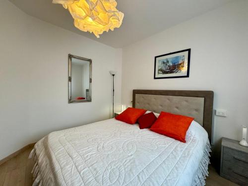 a bedroom with a bed with two red pillows at 1Dest - Waterfall & Pool with Garden in Riva del Garda