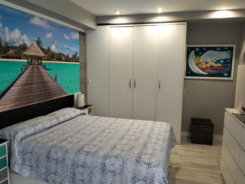 a bedroom with a bed and a view of a pier at Casa Cris in Córdoba