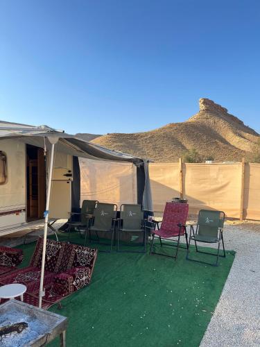 a tent with chairs and tables in front of it at كرفان vip مع ضيافة in Riyadh