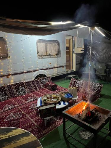 a living room with a table and a trailer at كرفان vip مع ضيافة in Riyadh