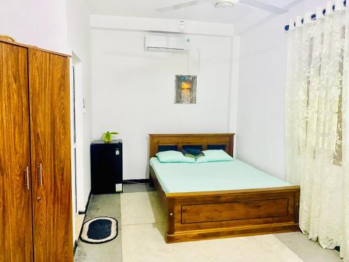 1 dormitorio pequeño con 1 cama y armario en Sorry we aren't available, en Ahangama