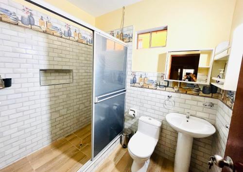 uma casa de banho com um chuveiro, um WC e um lavatório. em Sauce Suites - em Sauce