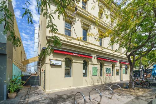 a building on the corner of a street at Clarendon Hotel in Melbourne