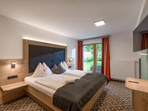 a bedroom with a large bed in a room at Gasthof Schöntal in Oberau