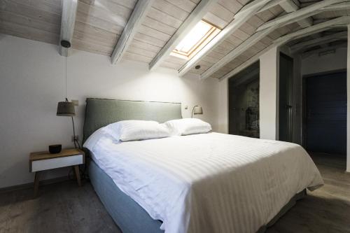 a bedroom with a large bed with white sheets at Alika Resort in Álika