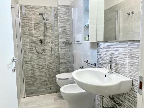 a bathroom with a toilet and a sink and a shower at Residence Hotel Angeli in Rimini