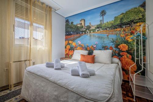 a bedroom with a large painting on the wall at Apartamento Esmeralda & Centro & Parking in Córdoba