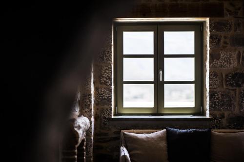 a window in a room with a dog standing next to it at Alika Resort in Álika